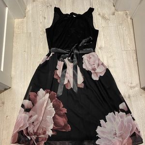Sleeveless black dress with floral skirt